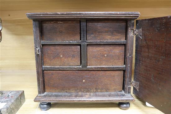 An inlaid oak spice cabinet, carved with the date, 1672 W.29cm